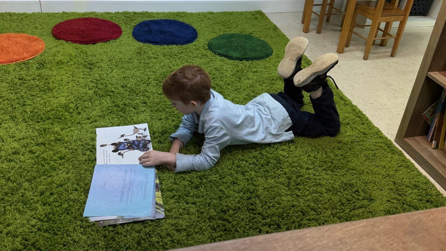 A young Carthage Christian Academy student reading a book